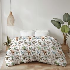 an unmade bed in a white room with green plants and potted plant next to it