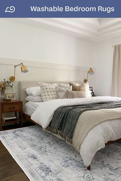 a large bed sitting on top of a wooden floor next to a window in a bedroom