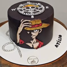 there is a cake decorated with an image of a man wearing a cowboy hat and holding his hand up to his face