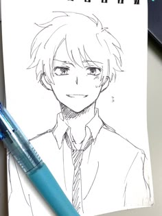 a drawing of an anime character on a piece of paper next to a blue marker