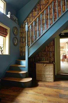 a staircase with bookshelves and wicker baskets