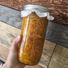 a person holding a jar filled with food