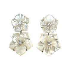 These exquisite Carved Mother of Pearl Floral Earrings are a perfect addition for any fashionista's wardrobe. Hand-crafted from double carved Mother of Pearl, these earrings are sure to make a delicate yet stylish statement. Perfect for any special occasion, these earrings are truly a luxurious piece of art. Small Double Carved Mother of Pearl Flower Drop Earrings Carved mother of pearl flower Round simulated diamond Hand set in sterling silver Available in 18k yellow gold vermeil or platinum rh Luxury White Gold Flower Earrings, Luxury Classic White Flower Earrings, Luxury White Flower-shaped Jewelry, Luxury White Gold Flower-shaped Earrings, Luxury Pierced Flower Earrings For Anniversary, Luxury White Flower-shaped Pearl Earrings, Luxury White Flower Shaped Jewelry, Luxury White Flower Earrings Fine Jewelry, Luxury Silver Sterling Silver Flower Earrings