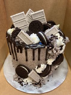 a cake decorated with oreo cookies and white frosting