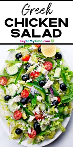 a white plate topped with a salad covered in lettuce, tomatoes and cucumbers