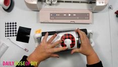 a woman is using a sewing machine to sew on the fabric with her hands