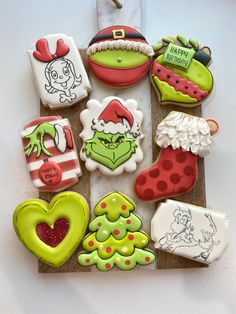 decorated cookies are arranged on a wooden board