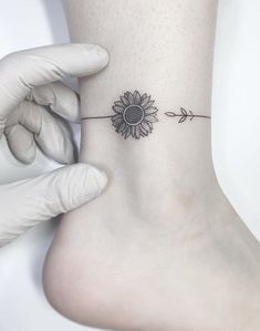 a person with a sunflower tattoo on their ankle