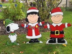 three cartoon characters are standing in the grass