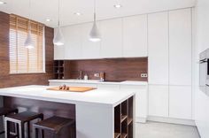 a kitchen with an island and stools in it