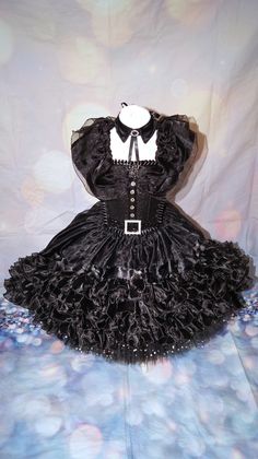 Luxury Wednesday Addams inspired tutu dress. Collar included. Dip hemmed skirt so knee length in the front going to floor length at the back. The top consists of a glitter material panel which is decorated. All of my tutus are made to order and consist of four layers of polyester tulle which makes it lovely and full. I use a combination of plain tulle and sequin tulle which gives the added wow factor.  My tutus are made on unlined crochet tops and glitter panels are added to the front. The tops are also felt backed to ensure the design does not cause any irritation to your little one. This tutu is designed at ankle length so if you could provide me with the measurement from waistline to ankle, I can make the dress accordingly. Made to order only. Sponge clean only, cannot machine wash. Bei Halloween Party Petticoat With Ruffles, Halloween Ruffled Petticoat For Party, Fitted Punk Costumes For Alternative Fashion, Fitted Punk Style Costumes For Alternative Fashion, Halloween Costume Petticoat With Attached Cancan, Halloween Costume Petticoat With Cancan, Fitted Halloween Dress For Alternative Fashion, Fitted Punk Halloween Costume, Black Overbust Costume For Costume Party