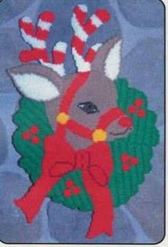 an embroidered deer with red and white bows on it's head