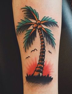 a palm tree tattoo on the arm