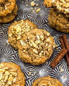 several cookies are on a plate with cinnamons and anise next to them,