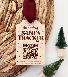 a christmas ornament with a qr code on it next to some fake trees