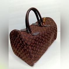 Authentic Vintage Well Kept 2006 Collection. Louis Vuitton Monogram Mini Lin Speedy 30 Handbag. Excellent Condition, Brown Cotton/Linen Blended Material, Lightweight. No Fade Or Frays Outside The Monogram Fabric. Very Little Wear Inside Lining & No Stains. Leather Trim Embellishments Of This Bag Has Very Little Blemishes In Which You Can Barely See With The Naked Eye, As Shown In Photos. -Monogram Mini Lin Pattern "Gold Metal Hardware Rolled Leather Handles Brown Colored Lining & A Single Interior Pocket With A Zip Closure At Top Date Code Sp0096 (No Padlock & Key) (I Also Included A Purse Organizer Until You Find One Of Your Choosing) Measurements Height 9.25 " Width: 12" Depth:7” Brown Monogram Canvas Shoulder Bag With Monogram Print, Brown Monogram Canvas Shoulder Bag, Brown Monogram Print Bag For Daily Use, Brown Monogram Print Bag For Shopping, Brown Monogram Shoulder Bag, Brown Monogram Print Bags For Shopping, Luxury Bags In Coated Canvas With Monogram Print, Luxury Bags With Monogram Print On Coated Canvas, Luxury Bags With Monogram Print And Coated Canvas