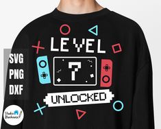 a man wearing a black sweatshirt with an image of a video game controller on it