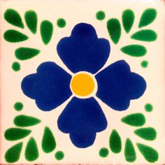 a blue flower with green leaves on a white and red square tile wall or floor