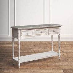 an old white table with two drawers on one side and a shelf on the other