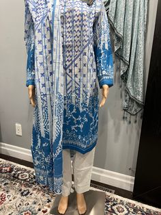 Explore Alkaram's Pret Collection with this stylish size 10 outfit, featuring a loose-fit design for a comfortable 20" chest. The ensemble includes a printed lawn kurta, matching cotton trousers, and a coordinating lawn dupatta. Perfect for casual wear, this set combines traditional elegance with modern comfort. Casual Patterned Sets With Printed Motifs, Patterned Cotton Sets With Long Sleeves, Casual Cotton Lawn Suit With Long Sleeves, Casual Long Sleeve Cotton Lawn Suit, Blue Block Print Long Sleeve Sets, Long Sleeve Blue Block Print Sets, Blue Long Sleeve Block Print Sets, Casual Lawn Suit For Eid, Casual Unstitched Long Sleeve Sets