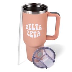 a pink coffee mug with the words delta on it and a straw in front of it