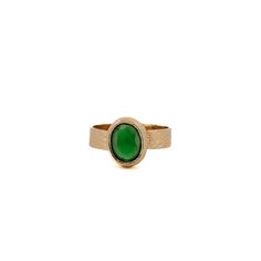 Cleopatra Gold And Green Jade Stone Adjustable Ring is a regal and captivating piece that effortlessly blends ancient allure with modern sophistication. This adjustable statement ring features a 24K gold-plated band that cradles a mesmerizing green jade gemstone, creating an adjustable and opulent accessory fit for a queen. Green Jade: Revered for its rich green hues, jade is a symbol of purity, harmony, and good fortune. The vibrant green of this gemstone not only evokes a connection to nature but also carries cultural significance, making it a fitting choice for a ring inspired by the legendary Cleopatra. The adjustable design ensures a comfortable fit, allowing you to showcase this piece with ease and style.  Details 24K gold plated brass Green Jade Gemstone Adjustable size 5'' to 8'' A Elegant Brass Rings With Cabochon, Elegant Brass Rings With Gemstone, Modern Emerald Cabochon Rings, April Birthstone Jewelry, March Birthstone Jewelry, Jade Gemstone, Gold Gemstone Ring, Forever Jewelry, Gold And Green