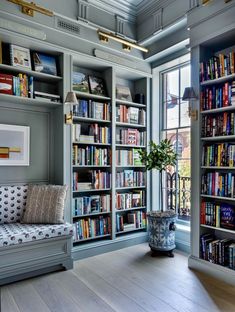 a room filled with lots of books and furniture next to a tall book shelf full of books