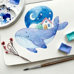 a drawing of a blue whale with a house on it's back and watercolor paints next to it