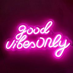 a neon sign that says good vibenlly on the side of a dark wall