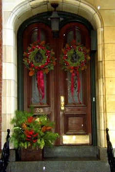 two wreaths on the front door of a building