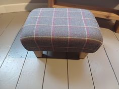 a small foot stool sitting on top of a hard wood floor