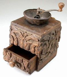 an old wooden box with a metal bowl on top