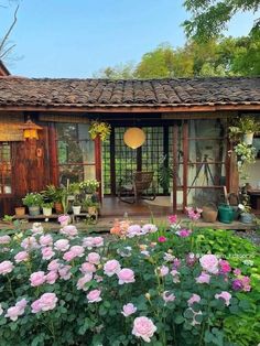 a small house with lots of flowers in the front yard