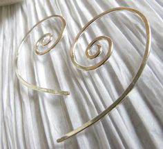 "These are our small open spiral hoop earrings, made from 20 gauge wire. Measures about 5/8\" diameter on the spiral and 1 1/8\" long We also offer a larger pair in our store. All of our jewelry will arrive boxed and ready to give as a gift. Made to order Larger pair crafted from 18 gauge... https://www.etsy.com/listing/62267488/open-spiral-hoop-earrings-handmade-from?ref=shop_home_active_3&frs=1 VISIT OUR SHOP: http://www.PoseidonsBooty.etsy.com SHOP POLICIES: http://www.etsy.com/shop/Posei Handmade Minimalist Spiral Hoop Earrings, Minimalist Spiral Hoop Earrings Handmade, Minimalist Handmade Spiral Hoop Earrings, Minimalist Spiral Hoop Earrings In Sterling Silver, Minimalist Spiral Sterling Silver Hoop Earrings, Adjustable Spiral Sterling Silver Wrap Earrings, Earring Handmade, Spiral Earrings, Shop Policies