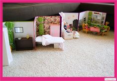 a doll house with furniture and accessories on the floor