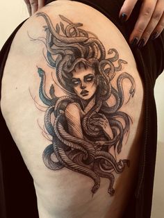 a woman with an octopus tattoo on her thigh