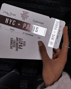 someone holding up two tickets for the new york and paris film festival in their hand