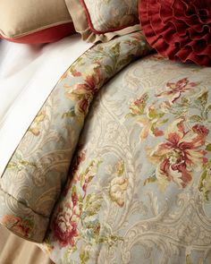 the comforter is made up with red and green pillows