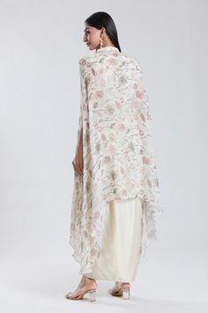 Ivory asymmetric cape with floral pattern and front tie-up. Paired with a top and dhoti skirt. - Aza Fashions White Traditional Drape Dupatta For Spring, White Dupatta For Spring With Traditional Drape, White Traditional Dupatta For Spring, Traditional White Dupatta For Spring, White Spring Dupatta In Traditional Drape, Traditional Silk White Shawl, White Georgette Dupatta For Spring, Fitted White Shawl, White Dupatta For Spring