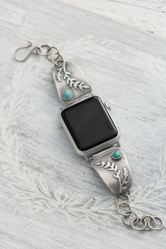 Handcrafted sterling silver and turquoise Apple watch band. Why be ordinary when you can be extraordinary! This band is not your ordinary band, every inch of it is hand made! Hand sawn floral/fern details are accented by a turquoise stone and  attached with a hand made sterling chain and clasp. When I got my Apple Watch I knew the first thing that had to go was that silicone band, it's great for sweating to the oldie but its not exactly pretty! So I designed this band.                   ⚠️♦️♦️ I Silver Watch Band, Bohemian Silver Watch Bands With Bracelet Strap, Bohemian Silver Bracelet Strap Watch Bands, Bohemian Silver Watch Band As Gift, Bohemian Silver Watch Bands As Gift, Silver Watch Bands With Polished Finish As Gift, Silver Polished Finish Watch Bands As Gift, Handmade Silver Watch Accessories Gift, Turquoise Watch Band