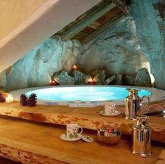 an indoor hot tub with candles on the counter