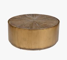 a round brass coffee table on white background