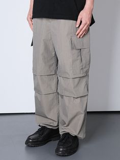 Editor's NotesThese cargo pants are built with room to move, and relaxed through the hip and thigh, with a full leg.Designed to keep you moving with maximum comfort and mobility.- Side cargo pockets- Adjustable waist and hem with string - Pleated knee design - Front and back pockets - More durable and more stylish- Fits perfectly everywhereMeasurements(in.)M/L/XL- Total length: 40.94in./42.13in./42.91in.- Waist: 13.39 to 17.31in./14.17 to 18.11in./15.75 to 19.69in.- Thigh: 14.17in./14.96in./15.75in. - Front rise: 11.81in./12.6in./13.39in.- Leg opening: 9.06in./9.45in./9.82in.Model Size Man - wearing L Height - 5’ 83”Weight - 150lbComposition & Care- 100% Nylon- Machine wash cold, hand wash cold, do not tumble dry  Designer- by KND Cargo Jeans With Pockets For Outdoor Activities, Urban Parachute Pants With Functional Pockets, Baggy Parachute Pants With Multiple Pockets For Outdoor, Functional Baggy Pants For Outdoor Activities, Wide Leg Parachute Pants With Pockets For Outdoor Activities, Khaki Parachute Pants With Belt Loops For Outdoor Activities, Khaki Parachute Pants With Belt Loops For Outdoor, Gray Cargo Pants With Pockets For Outdoor, Cargo Pants With Multiple Pockets For Outdoor Activities