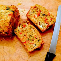 four pieces of bread sitting on top of a cutting board next to a knife