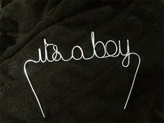 the word baby written in white wire on a black background