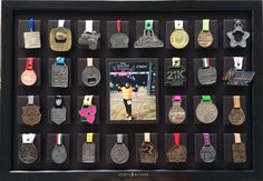 a shadow box is filled with medals and ribbons for the athletes who won in the olympics