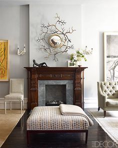 a living room filled with furniture and a fire place next to a painting on the wall