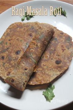 two tortillas on a white plate with parsley