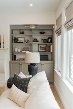 a living room filled with furniture and a lamp