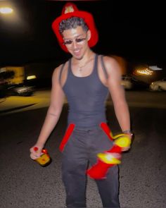 a man in grey shirt and red hat holding two yellow objects